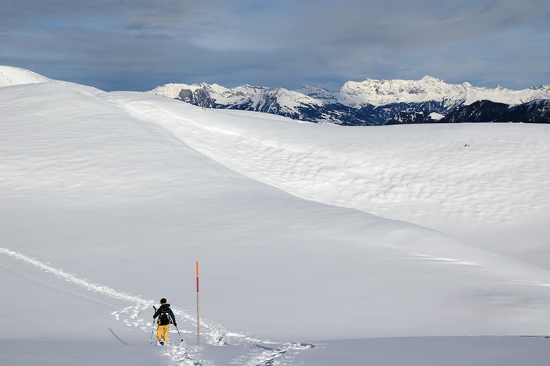 Un vaste plateau blanc entouré de sommets. On rejoint le Dreibündenstein par un doux relief de collines. Photos: Elsbeth Flüeler